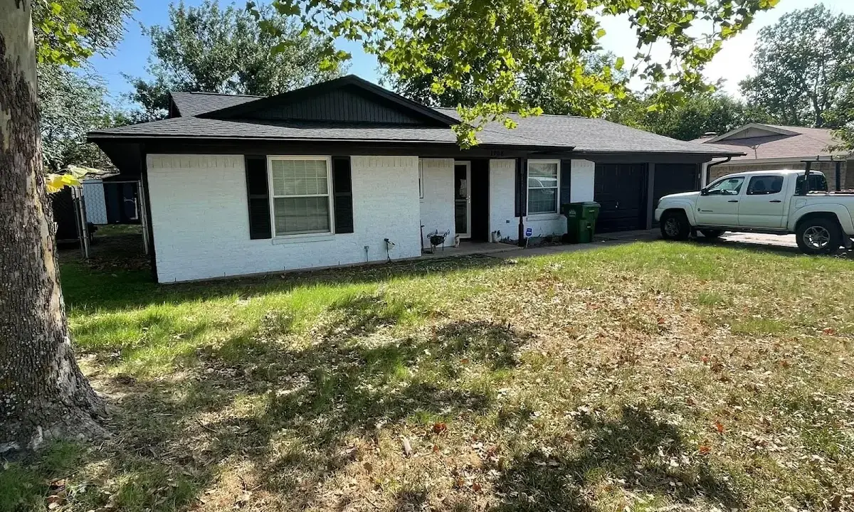 Professional roofing crew working on a residential roof in Wantage